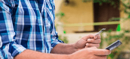 Young man using a smartphone to buy medicines from a verified canadian pharmacy